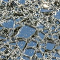 Shattered glass fragments are scattered, reflecting light and casting intricate Royalty Free Stock Photo