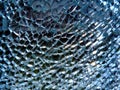 Shattered laminated safety glass macro view. abstract image with cracks and pattern