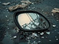 shattered car mirror on dark asphalt, a symbol of damage Royalty Free Stock Photo