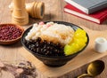 Shaved Ice with mango, red beans and rice ball served in bowl isolated on table top view of asian food Royalty Free Stock Photo