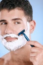 Shaving, beard and cosmetic man with cream for grooming isolated on a blue background. Skincare, beauty and model with Royalty Free Stock Photo