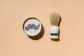 Shaving brush and shaving foam on camel color background. Spa organic foam. Zero waste concept