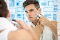 Shaving by electric shaver Royalty Free Stock Photo