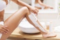 Shaving legs Royalty Free Stock Photo