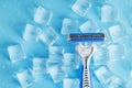 Blue shaving machine with sharp blades on the background of ice cubes close-up Royalty Free Stock Photo