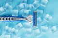 Blue shaving machine with sharp blades on the background of ice cubes close-up Royalty Free Stock Photo