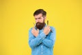 Shaving with a real blade sounds cool. Bearded man prepare shaving tools yellow background. Hipster hold shaving razor Royalty Free Stock Photo