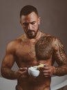 Shaving with a real blade sounds cool. Muscular latino man preparing shaving cream. Handsome hispanic guy holding