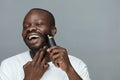 Shaving Routine For Male. Electric Razor Shaver Tool For Beard. Man Removes Facial Hair. Royalty Free Stock Photo