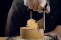 Shaving tete de moine cheese using girolle knife. Monks head. Variety of Swiss semi-hard cheese made from cows milk