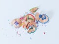 Shavings from multicolored pencils on white background Royalty Free Stock Photo