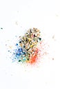 Shavings after sharpening of colored pencils lie in a heap on a white background. View from above Royalty Free Stock Photo