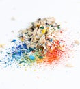 Shavings after sharpening of colored pencils lie in a heap on a white background. View from above Royalty Free Stock Photo