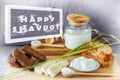 Shavuot. Photo to Jewish holiday - inscription Happy Shavuot with splash and drops milk on the background traditional products