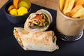 Shawarma dish in Middle Eastern cuisine meat cut into thin slices, stacked in a cone-like shape