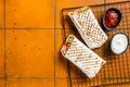 Shawarma durum doner kebab with meat and vegetable salad. Orange background. Top view. Copy space Royalty Free Stock Photo