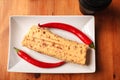 Shawarma pita bread with grilled chicken, shawarma dinner on a white square plate. Top view