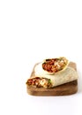 Shawarma, roll in lavash , grilled meat, with vegetables, sandwich , cut on a white background, vertical, copy spase