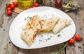 Shawarma sandwich or lavash with fresh vegetables and sauce on the gray plate decotated with cherry tomatoes, basil