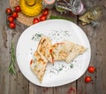 Shawarma sandwich or lavash with fresh vegetables and sauce on the gray plate decotated with cherry tomatoes, basil