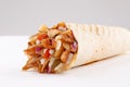 Shawarma wrap with onion and sauce on white background