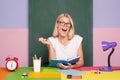 Shcool teacher in class on blackboard background. Professional portrait. Female student taking notes from a book at Royalty Free Stock Photo