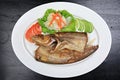 Sheatfishes Fish Fried with crispy garlic on a white plate Royalty Free Stock Photo