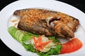 Sheatfishes Fish Fried with crispy garlic on a white plate Royalty Free Stock Photo