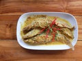 Sheatfishes in red curry sauce on dish Royalty Free Stock Photo