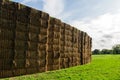 Sheaves of hay stacked into wall on the field in england uk on a sunny day Royalty Free Stock Photo