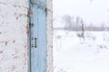 Shed with a blue wooden door. Winter Royalty Free Stock Photo