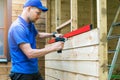 Shed construction - worker installing wooden facade planks Royalty Free Stock Photo