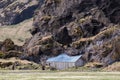 Shed of the Drangshlid farm built into the rock formation Drangurinn in Iceland