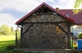 Shed with stacked firewood outdoors on sunny day Royalty Free Stock Photo