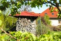 Shed with stacked firewood outdoors on sunny day Royalty Free Stock Photo