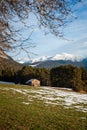 Shed on a sunny alpine winter meadow with melting snow, Wildermieming, Tirol, Austria