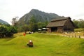 Sheep farm that is surrounded by mountains.