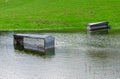 Sheep feeding stations in a flooded field Royalty Free Stock Photo