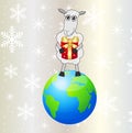 Sheep with a gift stands on a planet Earth Royalty Free Stock Photo