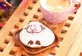 Sheep shape gingerbread and cup of milk with cinnamon sticks.