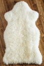 Sheepskin carpet on wooden background