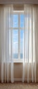 Sheer white curtains frame a bright ocean view window. Royalty Free Stock Photo