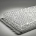 A sheet of clear bubble wrap is shown, with evenly spaced air-filled bubbles of circular Royalty Free Stock Photo
