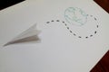 A sheet with a drawn planet and a paper plane