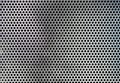 Sheet of metal covered with lines of circular holes Background Royalty Free Stock Photo