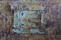 Sheet metal hatch for cleaning soot..Old rusty door with old layers of paint.