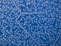 On a sheet of metal painted with blue paint, frost drew a snow pattern Royalty Free Stock Photo