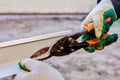 Sheet metal shears cut edge of window slope when installing trim of window opening from facade side. Royalty Free Stock Photo