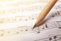 Sheet with music notes and pencil as background Royalty Free Stock Photo