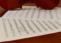 Sheet music and violin on wooden table. Top view classical musical instrument.